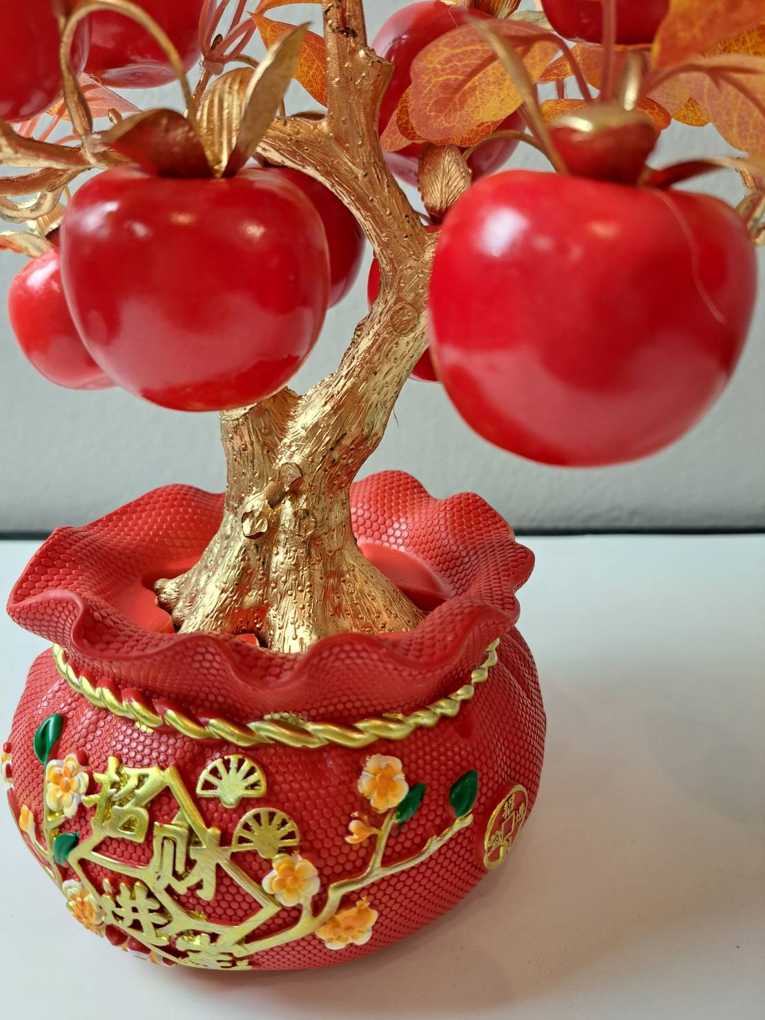 Decorative red ornamental pot with gold embossed floral motifs on Artificial Apple Tree N19