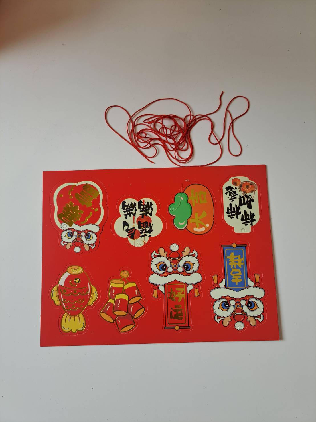 Festive decorative sticker sheet and red string included with Artificial Red Apple Tree N27