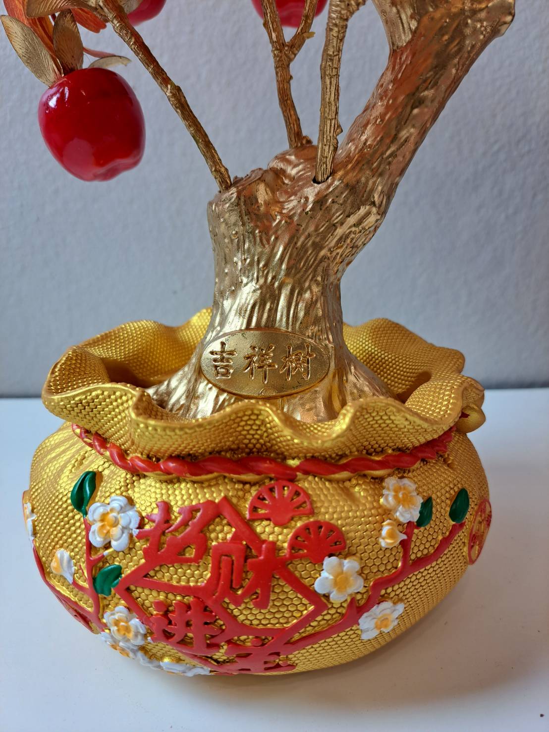 Detail of gold engraved 吉祥树 medallion on golden trunk base of Artificial Red Apple Tree N28