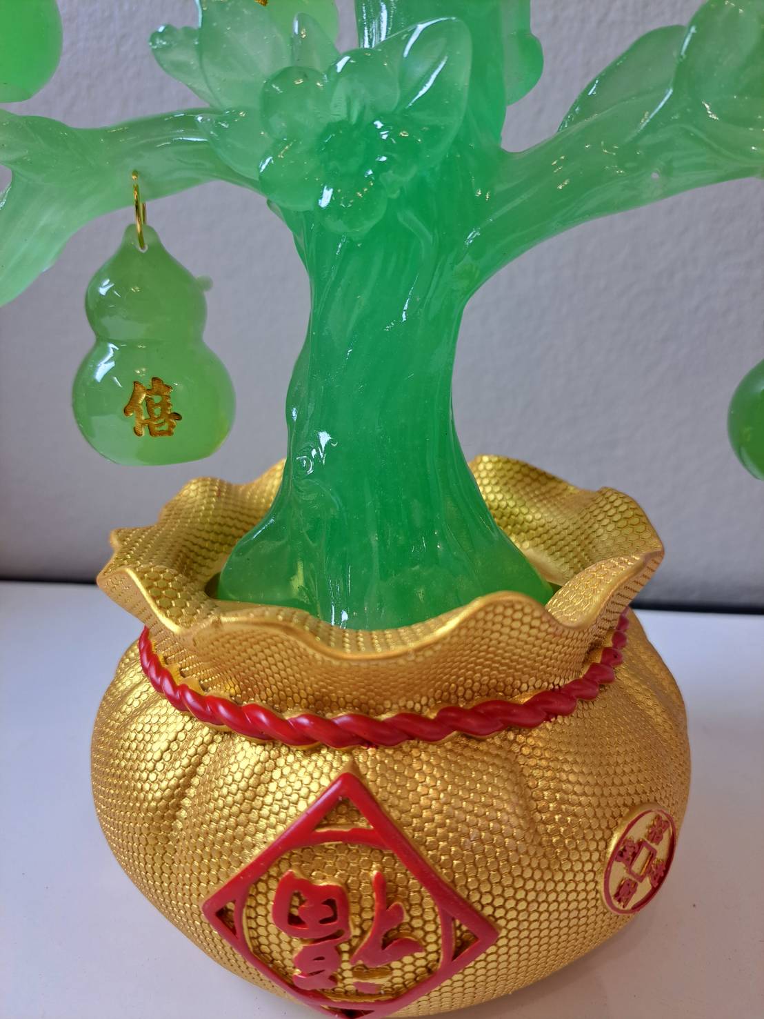 Side view of CX622 jade green gourd tree showing gold pot base and translucent green tree trunk