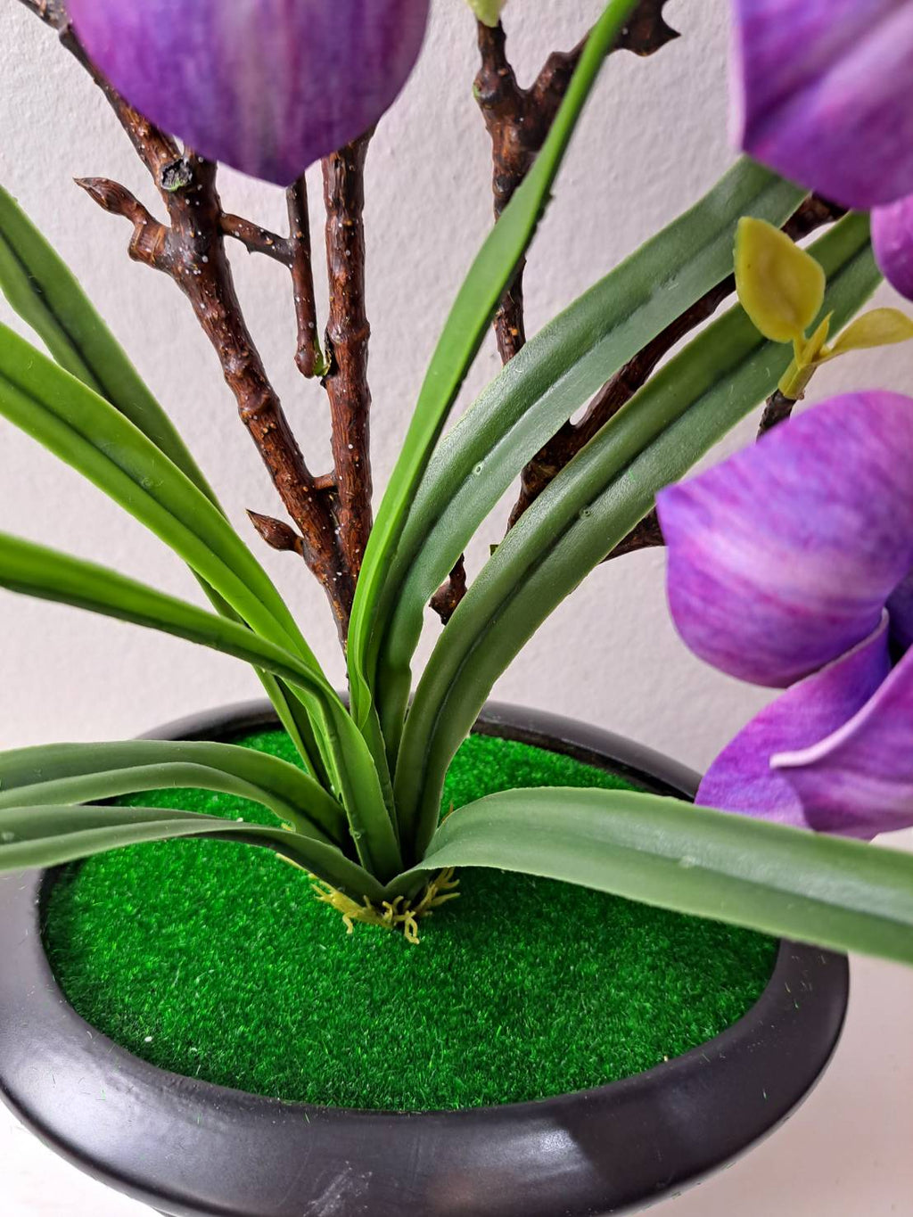 FT-257-D faux purple magnolia base with green grass and dark round ribbed pot