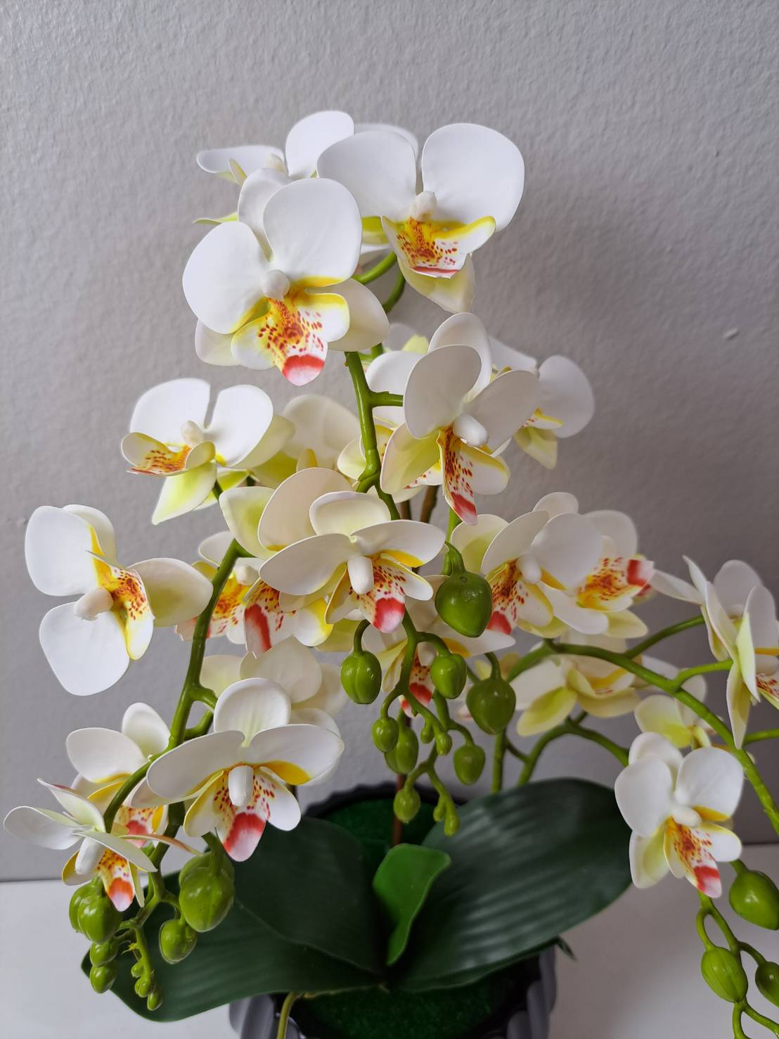 Faux white yellow orchid close-up blooms with buds