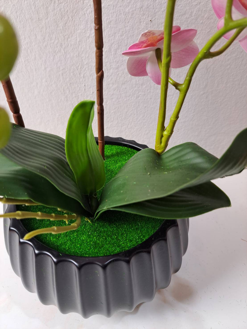Faux pink orchid full arrangement in black ribbed pot