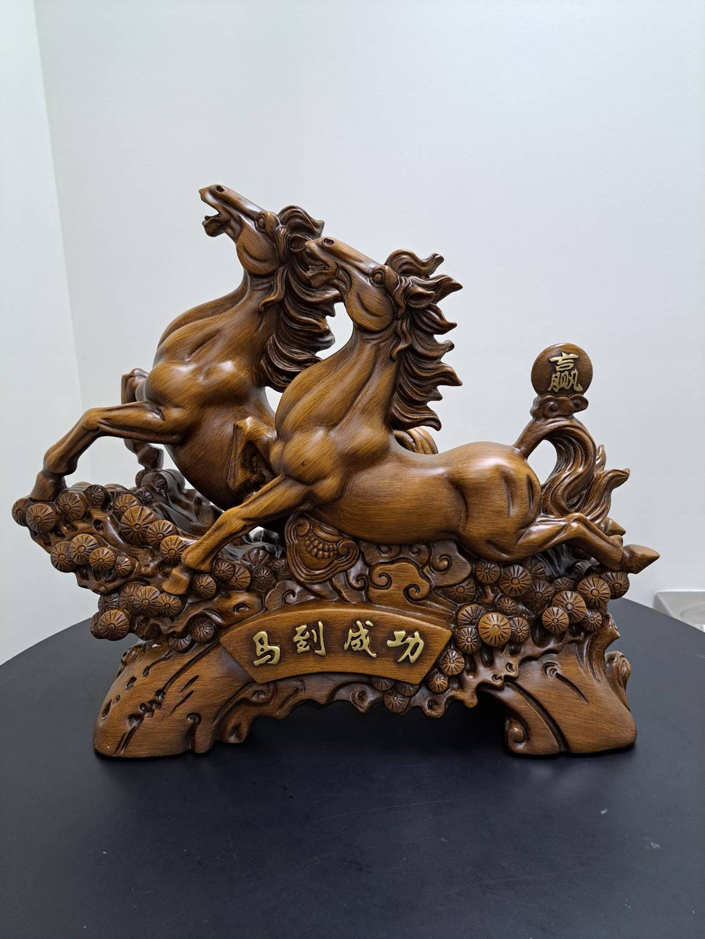 Detail of carved chrysanthemum coin cluster at base of dual galloping horses statue 6944-1