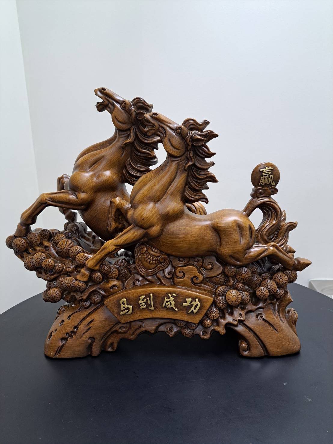 Detail of carved chrysanthemum coin cluster at base of dual galloping horses statue 6944-1