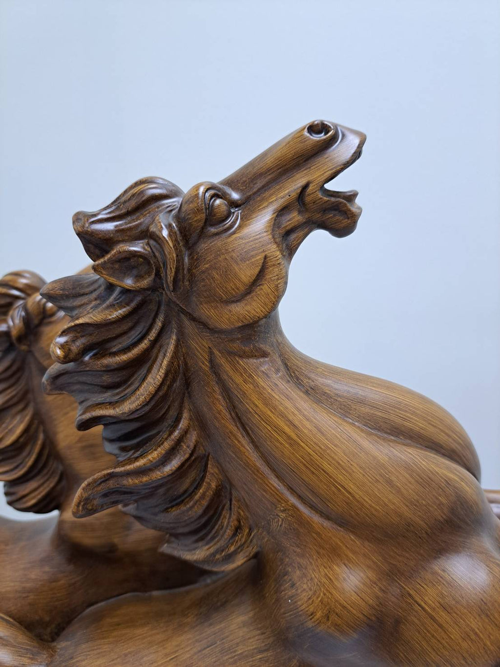 Three-quarter front view of 6944-1 dual horse statue showing 马到成功 gold inscription on base banner