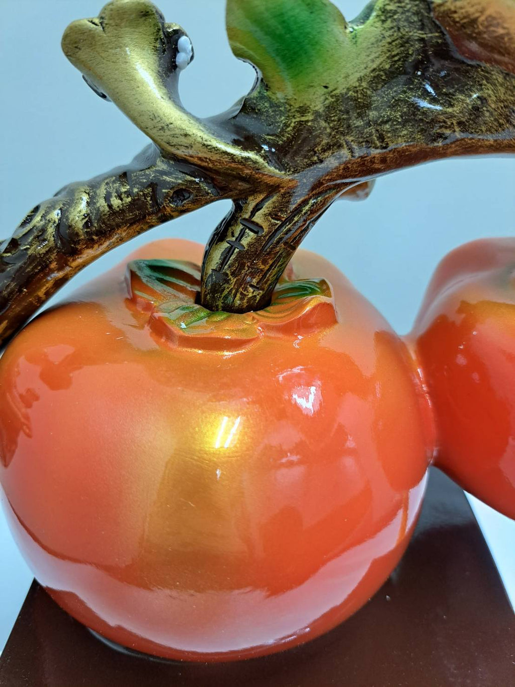 Close-up of large red-gold lingzhi mushroom with red gemstone center on ML-363 persimmon branch