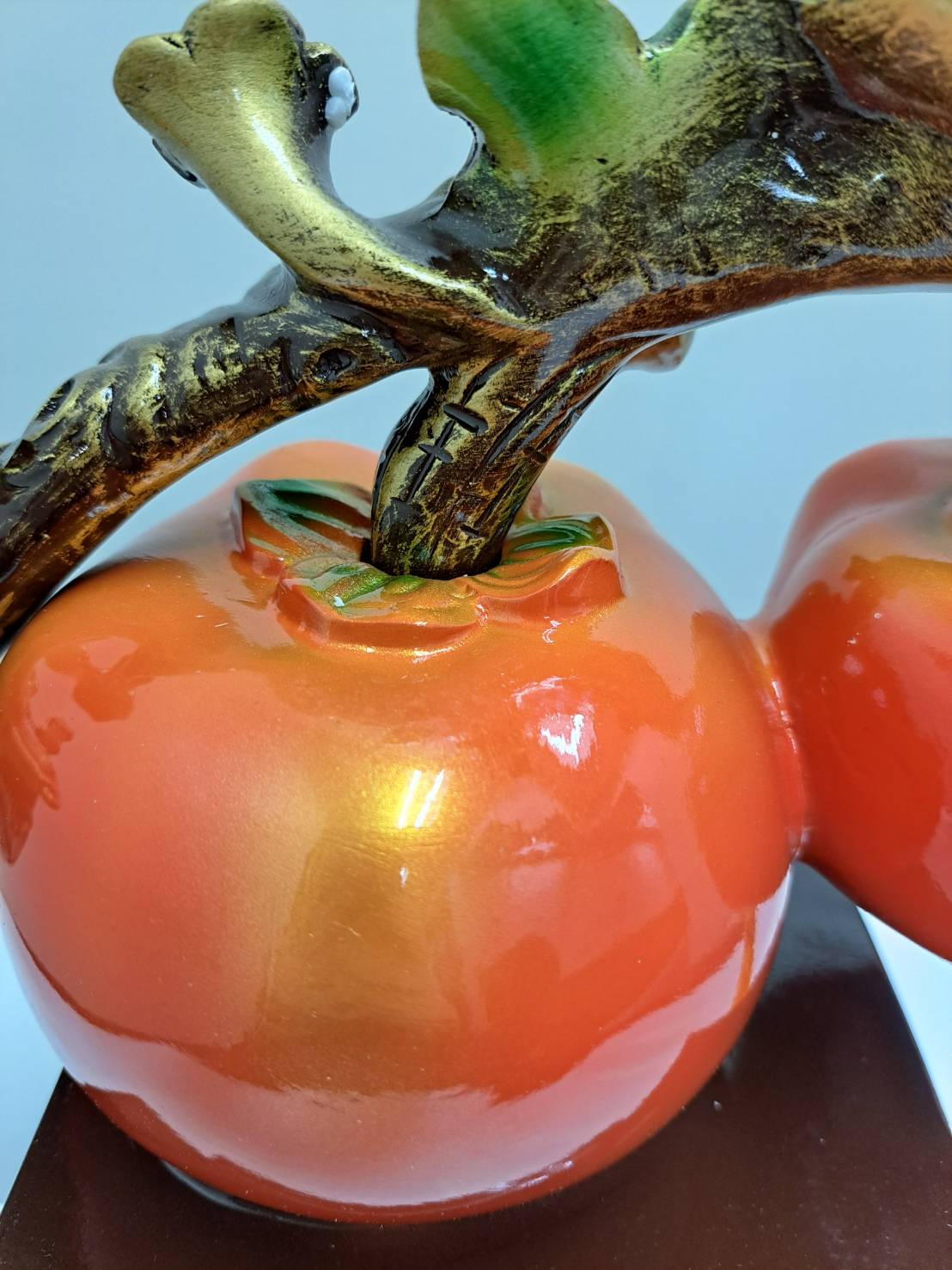 Close-up of large red-gold lingzhi mushroom with red gemstone center on ML-363 persimmon branch
