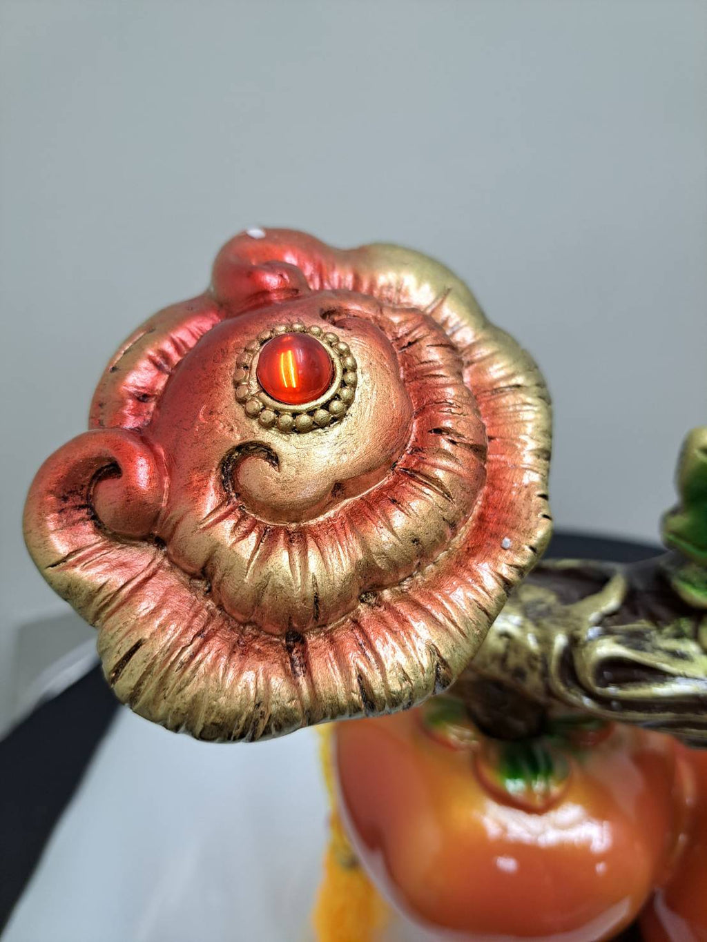 Side view of ML-363 showing gold-bronze branch with small lingzhi mushroom, flowers and green leaves