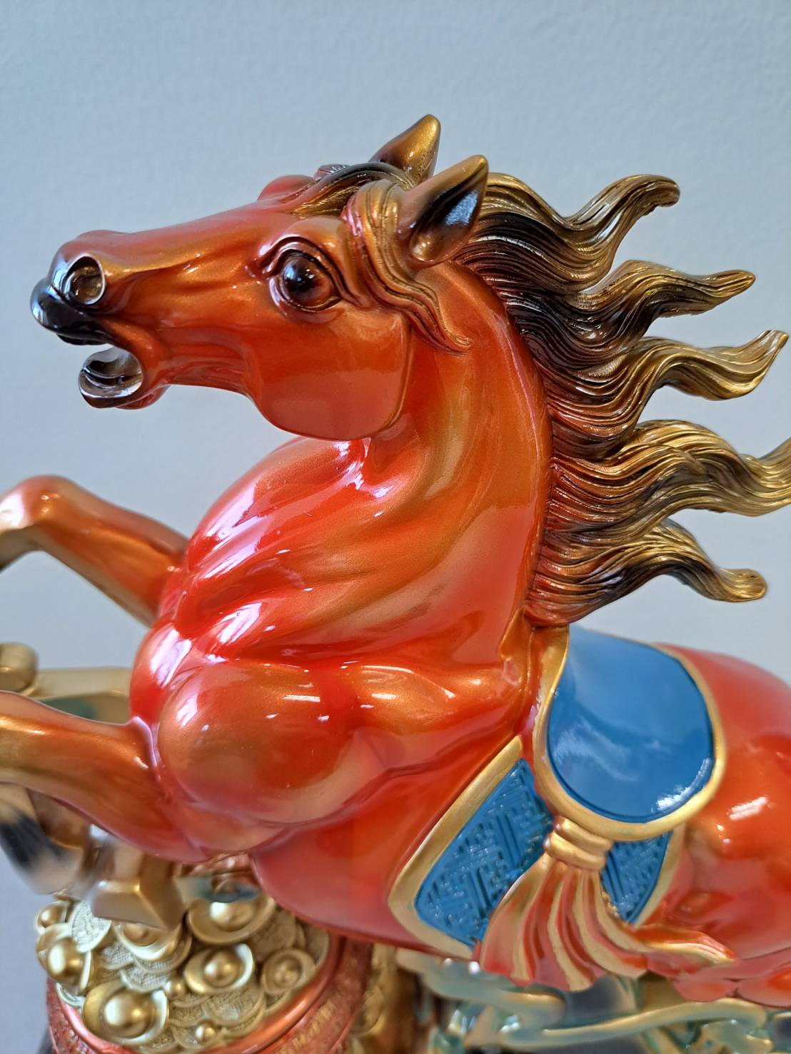 Side profile of rearing horse statue 7358-1 showing full body with blue gemstone saddle and gold coin base
