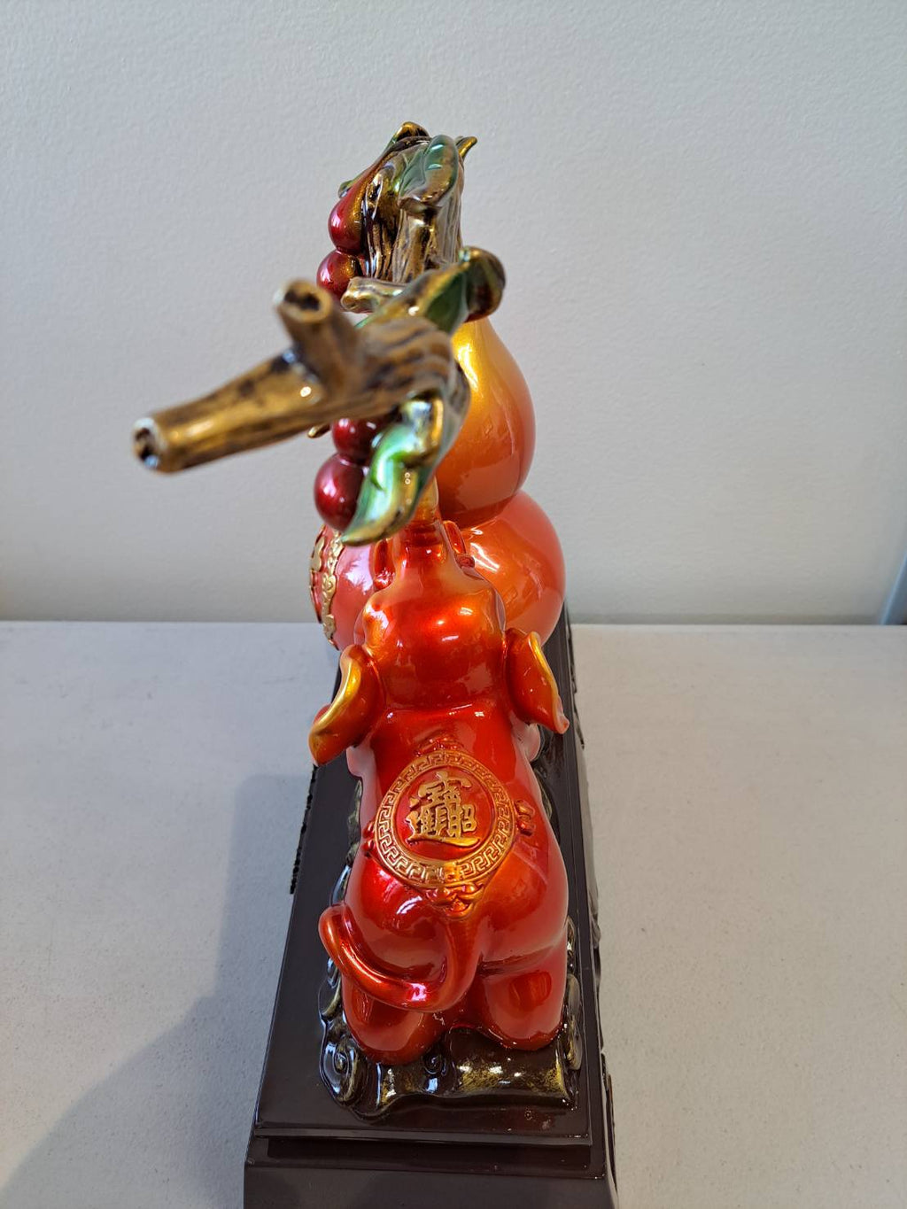 Side view of figurine 7314 showing elephant back with gold 龙 medallion and cherry branch canopy
