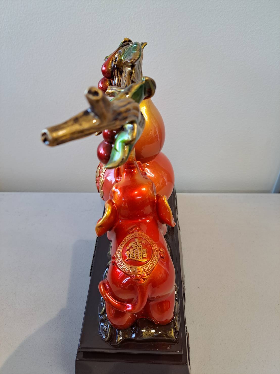 Side view of figurine 7314 showing elephant back with gold 龙 medallion and cherry branch canopy