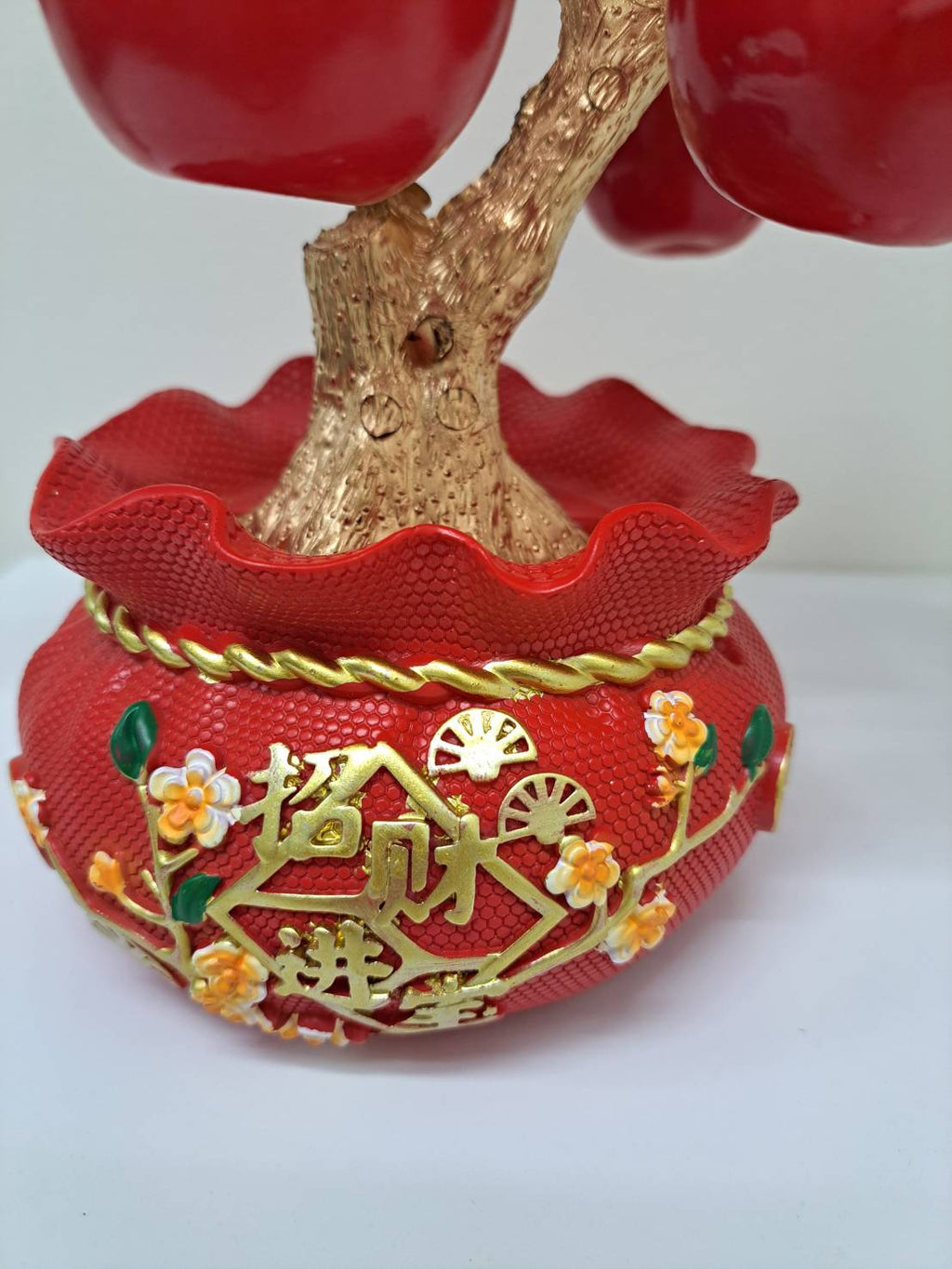 Side view of decorative red pot with gold characters on Artificial Apple Tree N19