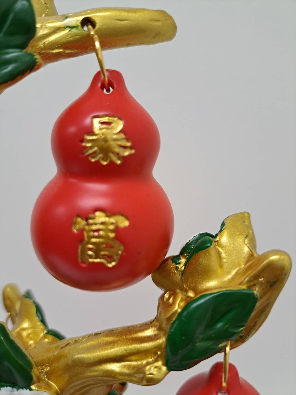 Multiple red gourd ornaments hanging from gold branches on Feng Shui Lucky Gourd Tree CX616 Red