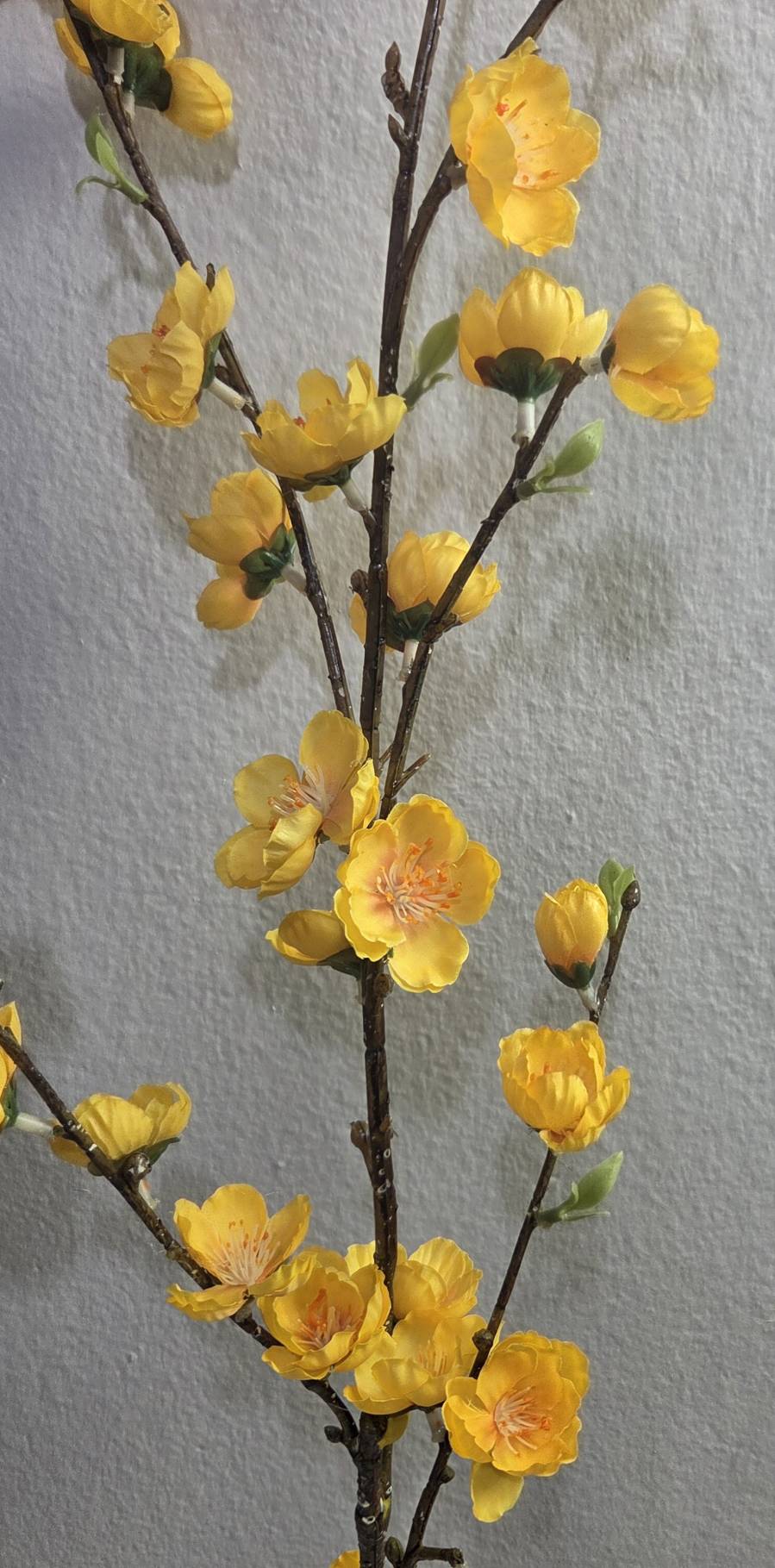 Faux yellow peach blossom branch close up detail