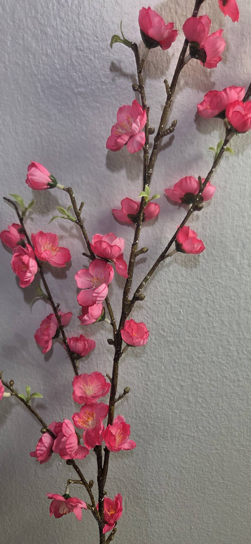 Faux hot pink peach blossom branch close up detail