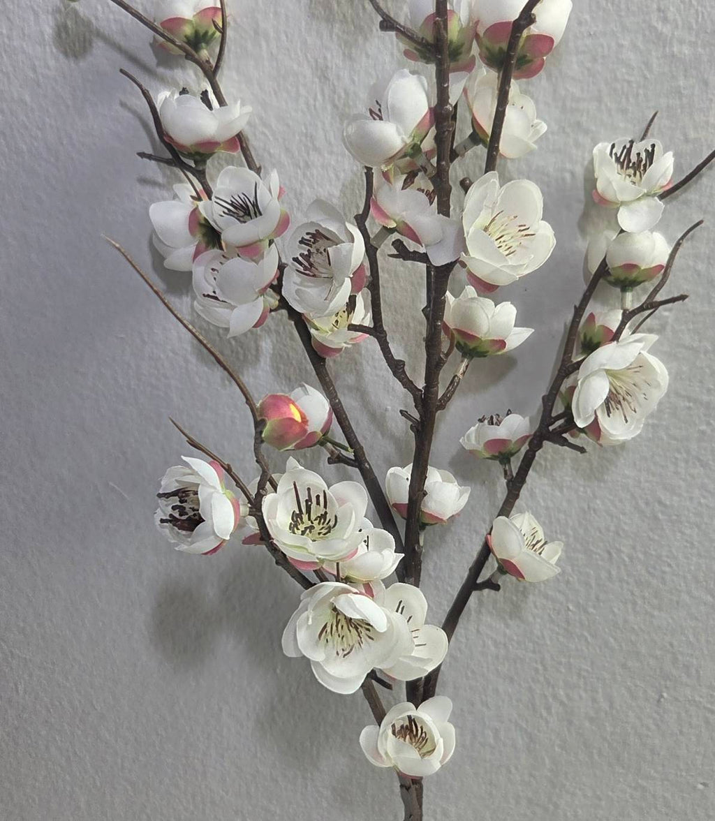 Faux white plum blossom branch close up detail