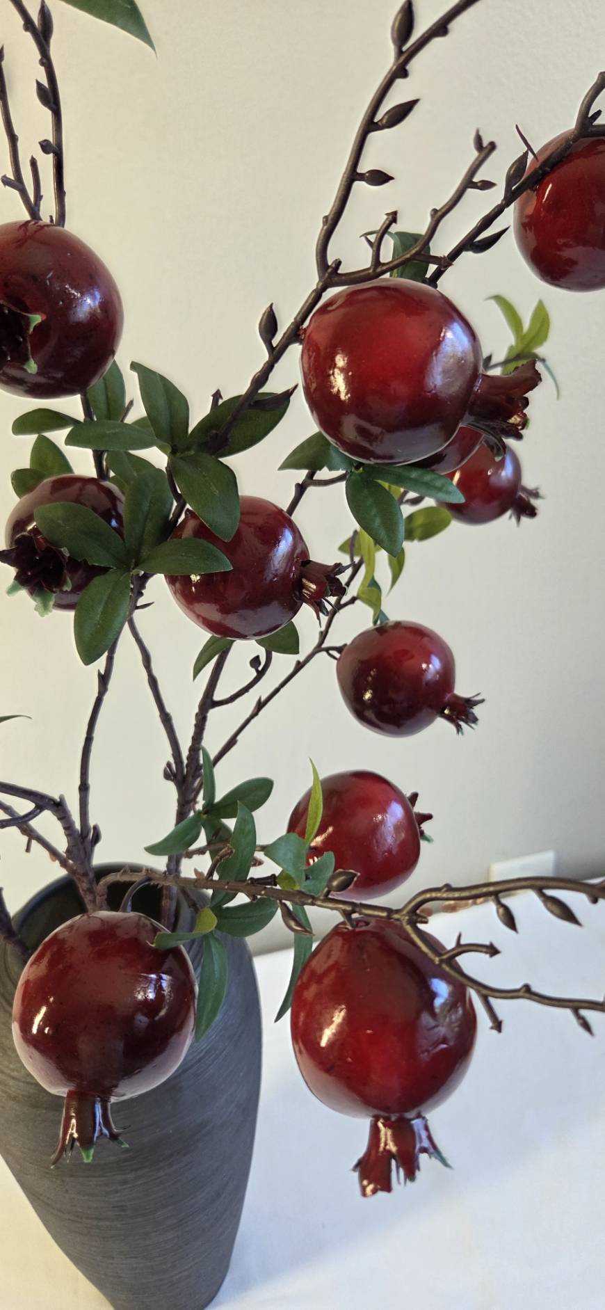 Faux pomegranate branch close up