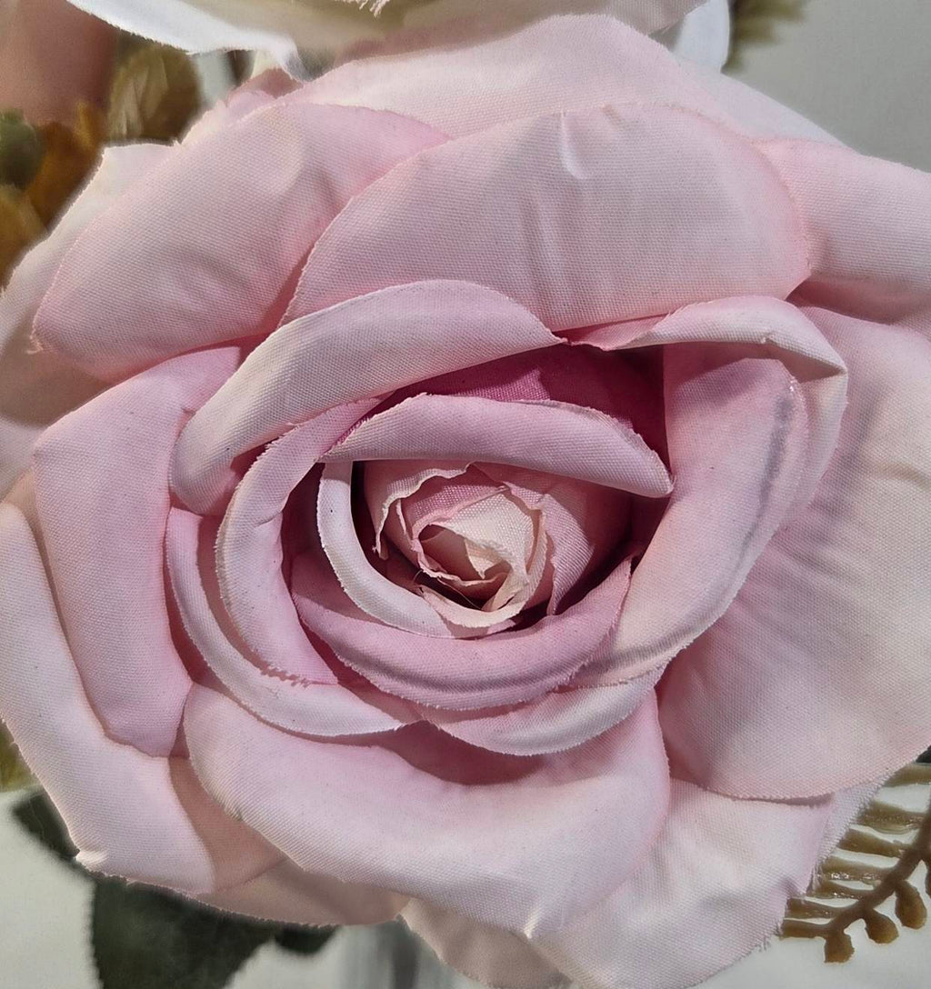 Top view of faux white and dusty pink rose bouquet with golden tendrils and bronze foliage accents