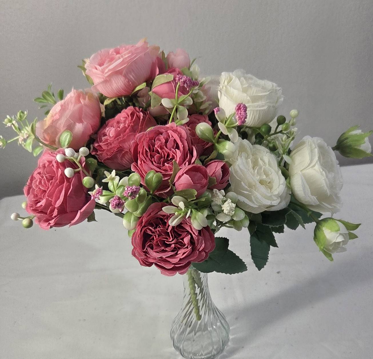 Faux Peony Rose Bouquet ROV-03 lifestyle - deep mauve peony bouquet on marble table with candle and scattered petals