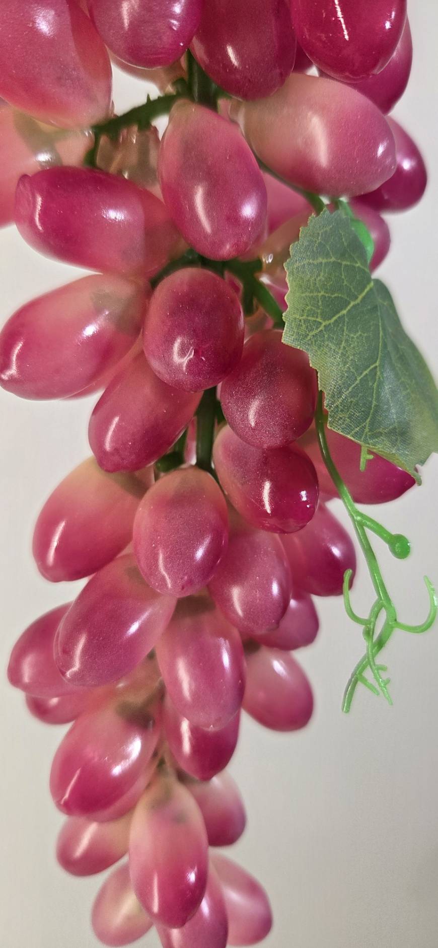Faux Red Grape Cluster GRT-01 side view - lifelike burgundy and blush red grapes with green curling tendrils and vine leaf