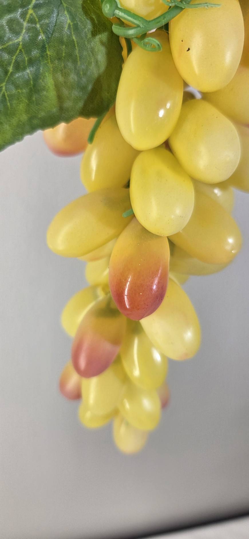 Faux Yellow Grape Cluster GRT-03 macro - elongated yellow faux grapes with rosy blush tips and green stem detail