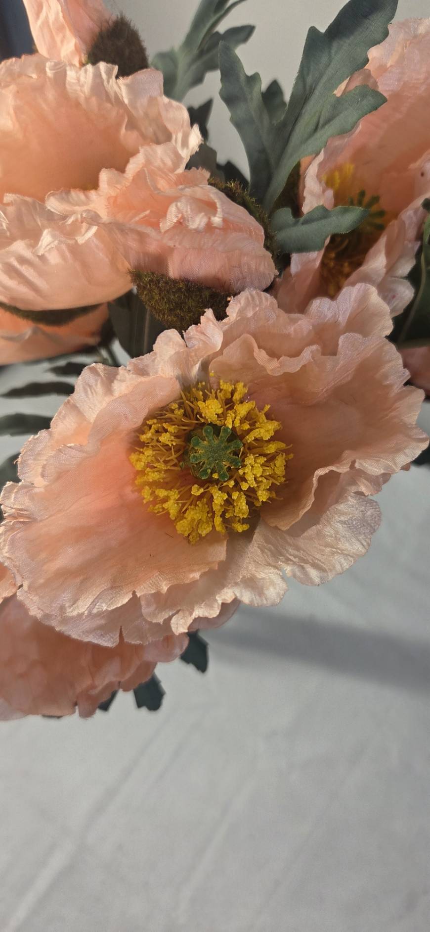 Close-up of multiple faux peach poppy blooms with sage-green foliage - PPY-02