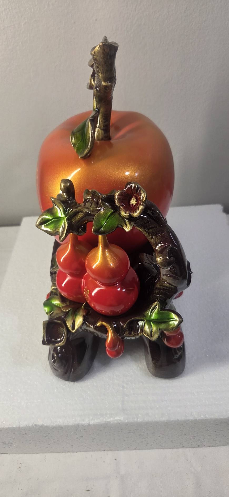 Front view of large red-orange peach with gold 福 character in ornate medallion on statue 7279