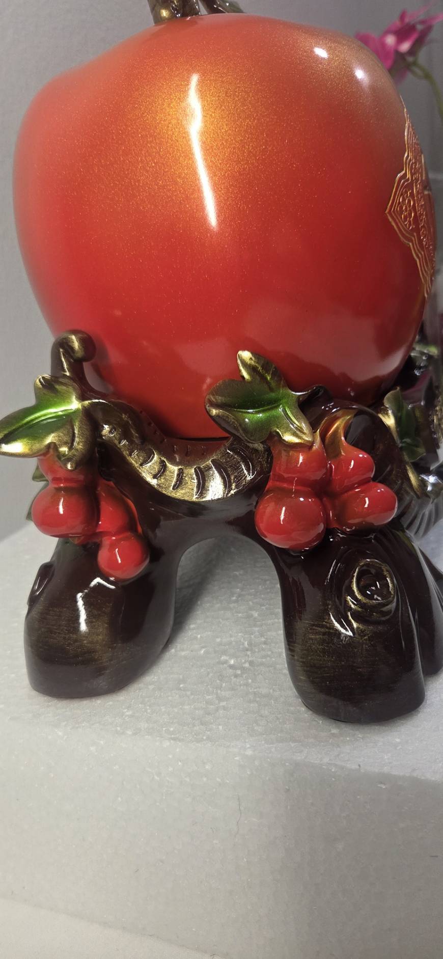 Side view of Peach of Immortality Statue 7279 showing full composition with gold-bronze bamboo stem and green leaves