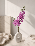 Faux Purple Phalaenopsis Orchid Stem OCT-04 - styled in white ceramic vase on table with books