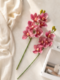 Faux Pink Cymbidium Orchid Stem ORA-03 - lifestyle flat lay with linen and book
