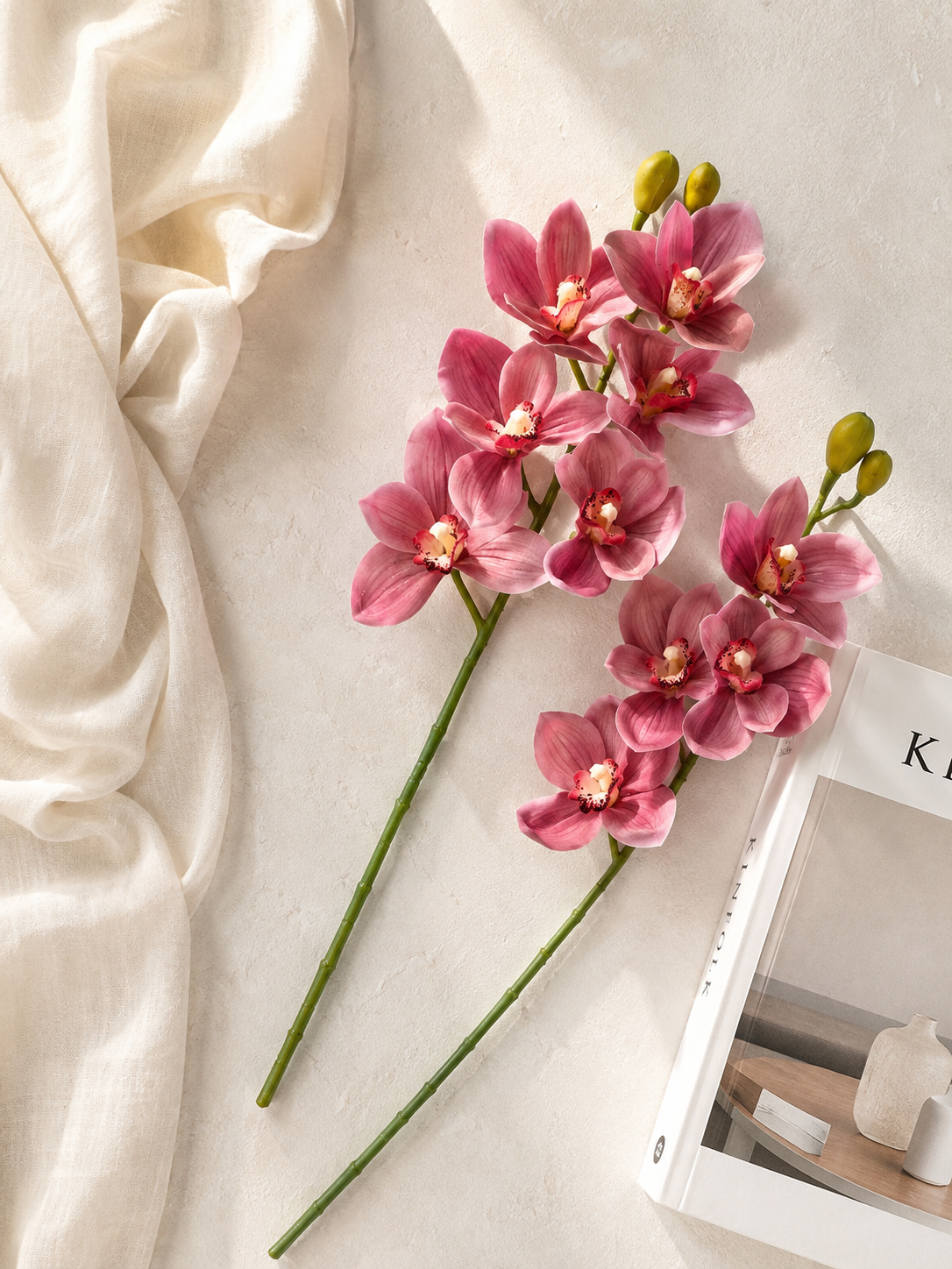 Faux Pink Cymbidium Orchid Stem ORA-03 - lifestyle flat lay with linen and book