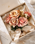 AI lifestyle render of faux champagne and dusty rose bouquet styled in elegant home decor setting