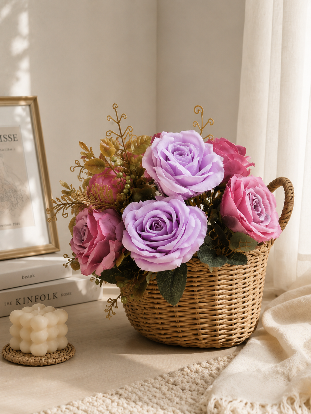 AI lifestyle render of faux lavender and mauve rose bouquet styled in wicker basket on neutral home decor setting with candle and Kinfolk books