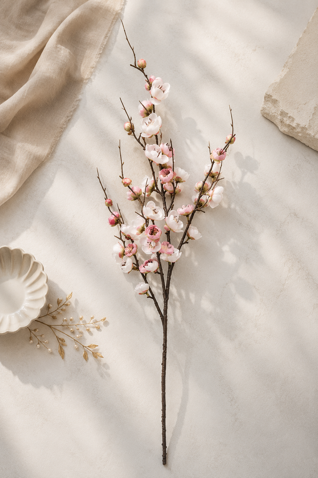White pink plum blossom branch lifestyle flat lay