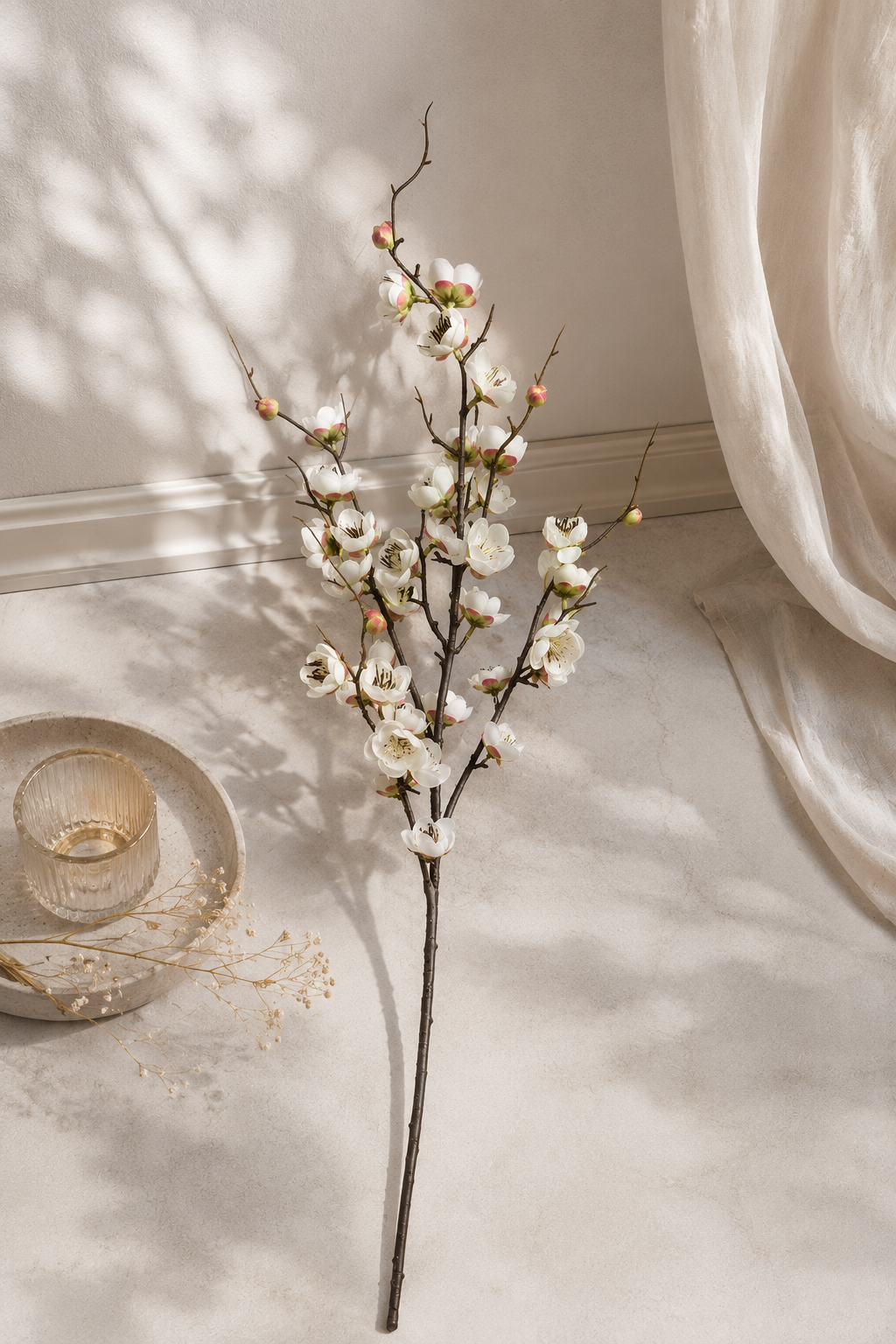 White plum blossom branch lifestyle on marble floor