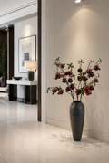 Faux pomegranate branch in tall vase - lifestyle