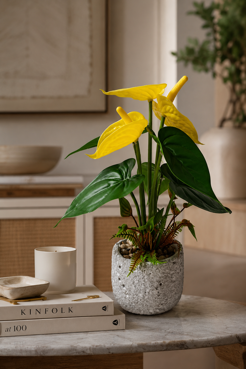 Faux yellow anthurium lifestyle on coffee table in modern living room