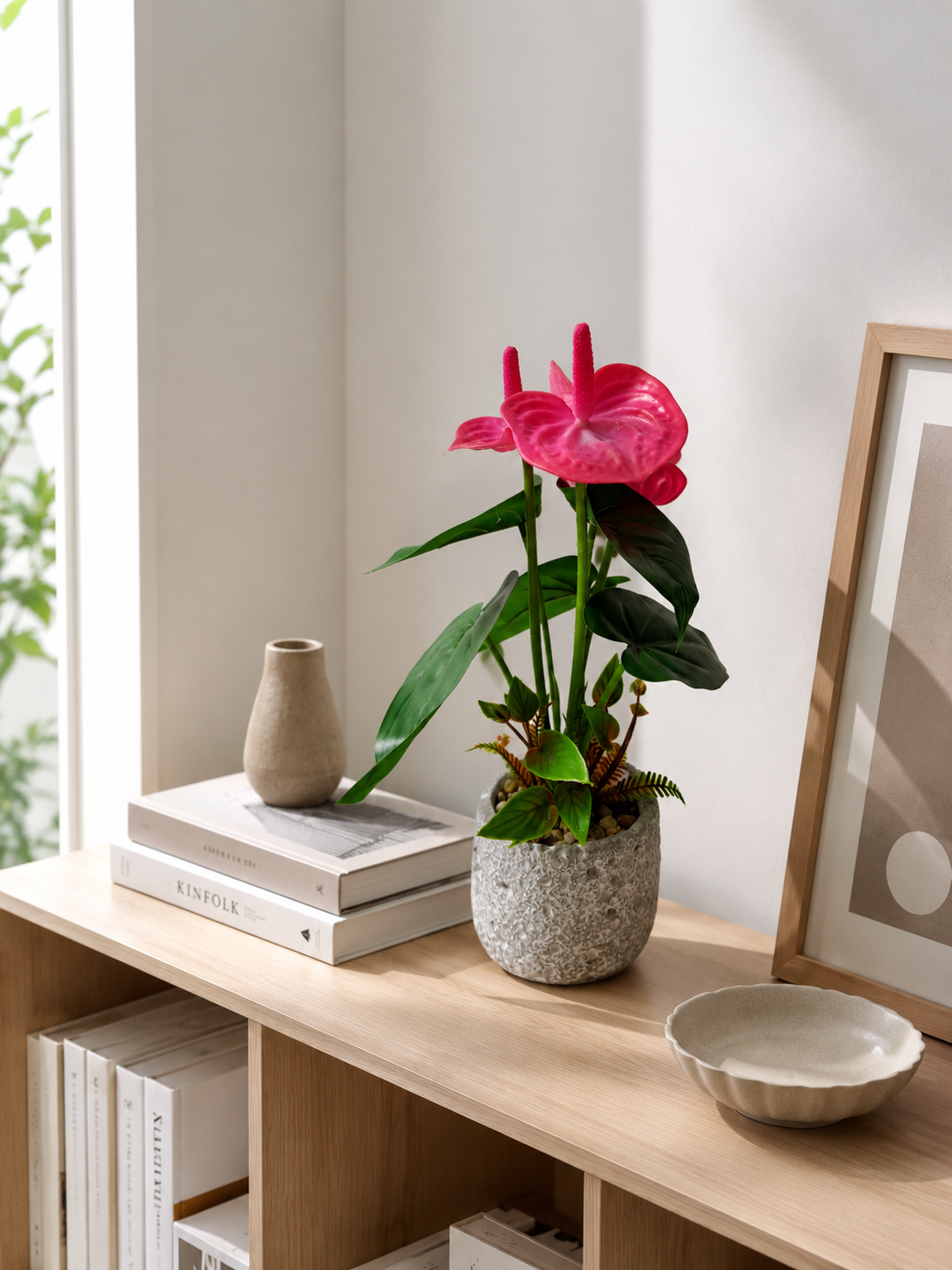 Faux pink anthurium lifestyle on bookshelf in modern Scandinavian living room