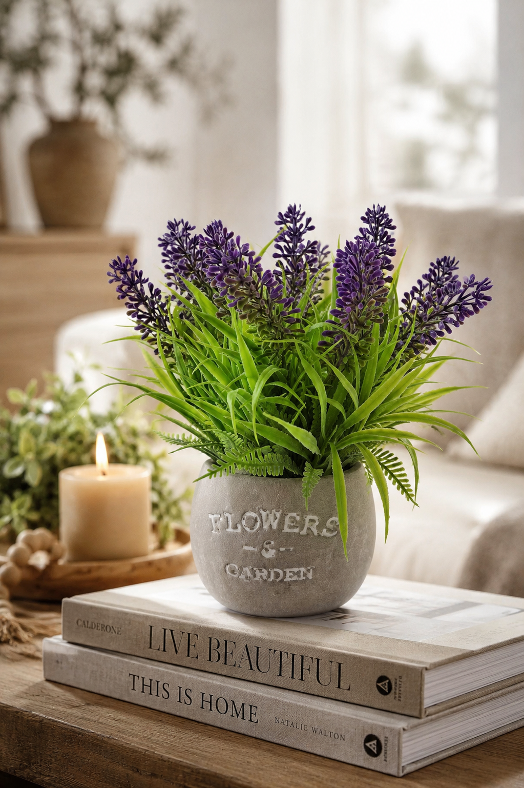 Faux lavender plant lifestyle on coffee table with candle and books